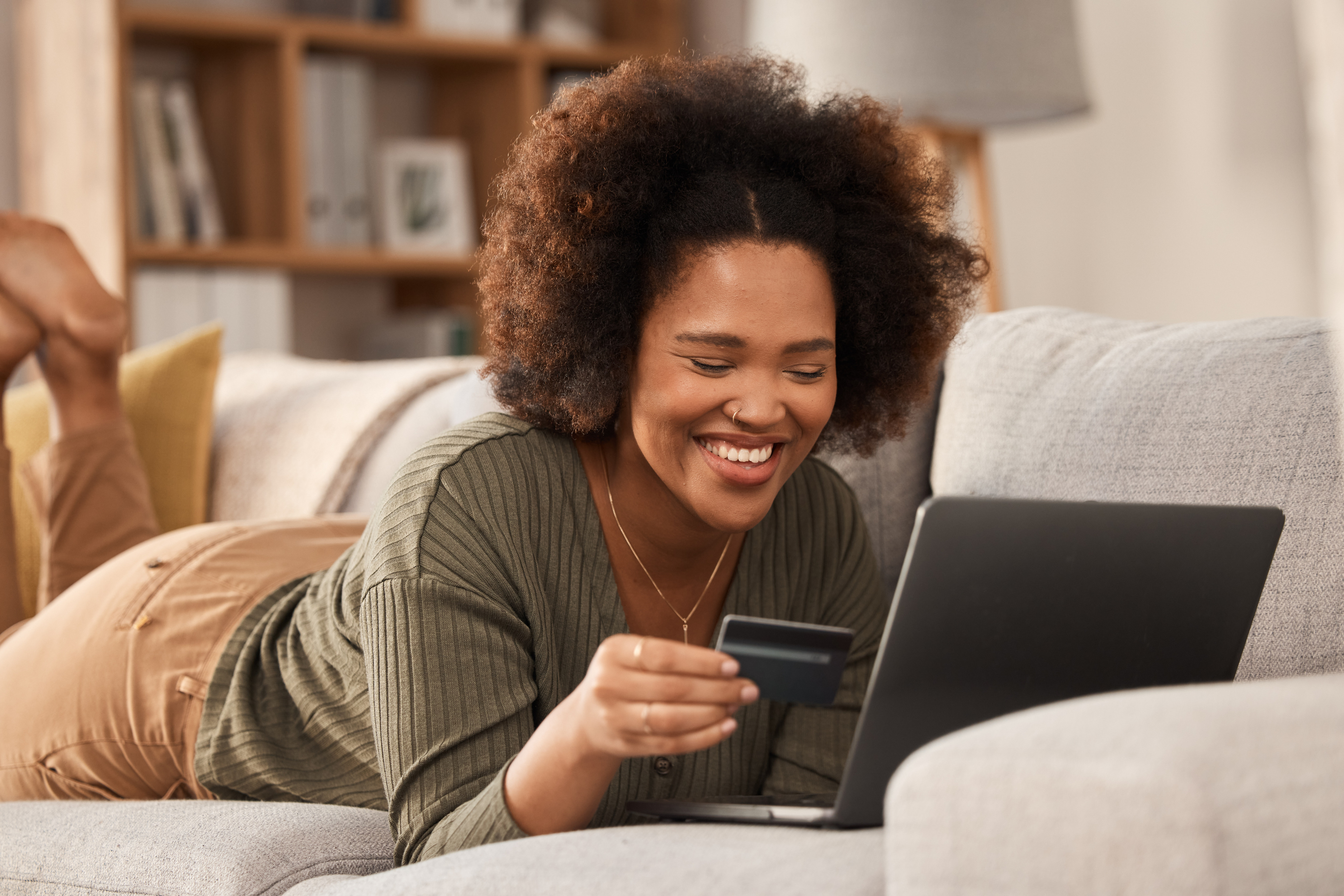 Woman making online purchase with credit card and laptop